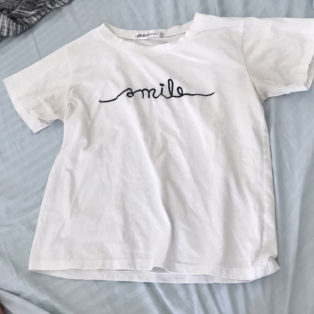 White cropped top with smile in cursive